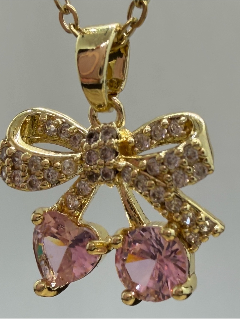 Gold Bow Pendant Necklace with Pink Gemstones